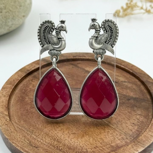 Regal Charm: Antique Silver Peacock Earrings with Ruby Red Teardrops